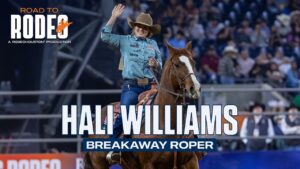 Rodeo poster showing a smiling female rider on a horse, waving, with bold text reading 'HALI WILLIAMS' and 'BREAKAWAY ROPER' and a 'Road to Rodeo' logo in the top-left. Crowd in the background.
